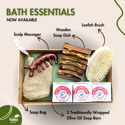 Bath Essentials set including a wooden scalp massager, body brush, soap bag, wooden soap dish, and three Traditionally Wrapped Olive Oil Nablus soap bars.