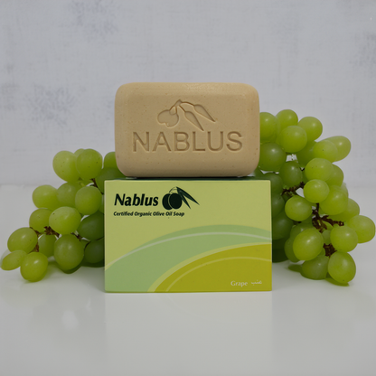 Grape and olive oil soap with green grapes around it